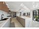 Open-concept kitchen featuring island with seating and floor to ceiling windows nearby at 6178 9Th Avenue Ne Cir, Bradenton, FL 34212