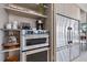 Modern kitchen featuring stainless steel appliances, a built-in oven, and views to the water at 6178 9Th Avenue Ne Cir, Bradenton, FL 34212