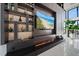 Living room showcases a modern fireplace and custom shelving beside floor-to-ceiling windows at 6178 9Th Avenue Ne Cir, Bradenton, FL 34212
