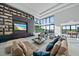 Beautiful living room with cozy seating, modern fireplace, custom built-in shelving, and stunning water views at 6178 9Th Avenue Ne Cir, Bradenton, FL 34212