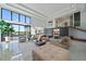 Bright living room boasts floor-to-ceiling windows and a view of the pool and waterway at 6178 9Th Avenue Ne Cir, Bradenton, FL 34212