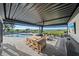 Covered patio with a dining area, lounge seating, outdoor kitchen, and pool overlooking the bay at 6178 9Th Avenue Ne Cir, Bradenton, FL 34212
