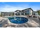 Rear of a modern home with an inviting pool and an outdoor seating area at 6178 9Th Avenue Ne Cir, Bradenton, FL 34212