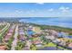 Aerial view of the community with stunning water views, lush landscaping, and beautiful homes with pools at 6211 Legends Blvd, Bradenton, FL 34210