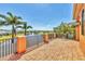 Spacious brick balcony overlooking a serene pond and lush tropical landscaping on a sunny day at 6211 Legends Blvd, Bradenton, FL 34210