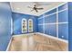 Bedroom featuring blue walls with white molding, two windows, and luxury vinyl plank flooring in a herringbone pattern at 6211 Legends Blvd, Bradenton, FL 34210