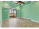 Bright bedroom with tray ceiling and sliding glass doors to the outdoor living space at 6211 Legends Blvd, Bradenton, FL 34210