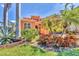 Landscaped front yard featuring vibrant plants and trees, adding curb appeal to the property at 6211 Legends Blvd, Bradenton, FL 34210