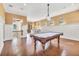 Large game room with a pool table, hardwood floors, and wainscoting at 6211 Legends Blvd, Bradenton, FL 34210
