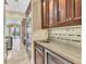 Kitchenette featuring granite countertops, a stainless steel refrigerator, and custom wood cabinetry at 6211 Legends Blvd, Bradenton, FL 34210