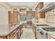Spacious kitchen featuring stainless steel appliances, a large island, and ample cabinet space at 6211 Legends Blvd, Bradenton, FL 34210