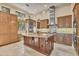 Spacious gourmet kitchen featuring a large island, custom cabinets, and modern appliances at 6211 Legends Blvd, Bradenton, FL 34210
