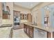 Gourmet kitchen with a center island, stainless steel appliances, and custom cabinetry at 6211 Legends Blvd, Bradenton, FL 34210