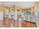 Open landing with hardwood floors, columns, bar with seating, and bright natural light at 6211 Legends Blvd, Bradenton, FL 34210