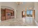 Elegant living room with tile flooring, a high ceiling, and outdoor views, complete with built-in cabinetry at 6211 Legends Blvd, Bradenton, FL 34210