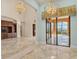 Bright living room showcasing the tile floors and view to the patio at 6211 Legends Blvd, Bradenton, FL 34210