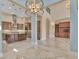 Large living room with high ceilings, open floor plan, and views of the gourmet kitchen at 6211 Legends Blvd, Bradenton, FL 34210