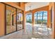 Open-air patio with tile flooring and a screened enclosure offering views of the surrounding property at 6211 Legends Blvd, Bradenton, FL 34210