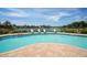 Inviting community swimming pool with a beautiful view, surrounded by lounge chairs and meticulously maintained grounds at 6211 Legends Blvd, Bradenton, FL 34210