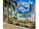 Welcome to Harbor Cove, a waterfront community with lush landscaping, palm trees and a community sign at 705 Riverview Cir, North Port, FL 34287