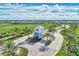 Aerial view of the gated community entrance with lush landscaping, palm trees, and well-manicured grounds at 9487 Tequila Sunrise Dr, Sarasota, FL 34241
