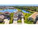 Stunning two-story home boasts lake views, manicured lawn, and a three-car garage in a desirable neighborhood at 9487 Tequila Sunrise Dr, Sarasota, FL 34241
