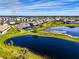 Expansive aerial view of home showcasing prime location near lake, lush landscaping and surrounding community at 9487 Tequila Sunrise Dr, Sarasota, FL 34241