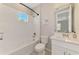 Bright bathroom features subway tile, tub/shower, white vanity and modern sink with large framed mirror at 9487 Tequila Sunrise Dr, Sarasota, FL 34241