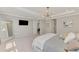 Spacious bedroom with large mirror, television, pendant lighting and ensuite bathroom at 9487 Tequila Sunrise Dr, Sarasota, FL 34241