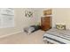 Cozy bedroom featuring twin beds, neutral walls, and decor at 9487 Tequila Sunrise Dr, Sarasota, FL 34241