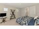 Cozy bedroom with a unique bookshelf, TV, and blue patterned bedding at 9487 Tequila Sunrise Dr, Sarasota, FL 34241