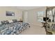 Bedroom with a decorative bookcase and a marble topped accent table has a window view of the neighborhood at 9487 Tequila Sunrise Dr, Sarasota, FL 34241