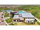 Aerial view of the community center, featuring pools, modern architecture, and well-maintained grounds at 9487 Tequila Sunrise Dr, Sarasota, FL 34241