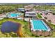 Aerial view showcases an array of community pools, manicured landscaping, and ample parking at 9487 Tequila Sunrise Dr, Sarasota, FL 34241