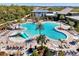 Aerial view of an amazing community pool with surrounding amenities and lush tropical landscaping at 9487 Tequila Sunrise Dr, Sarasota, FL 34241
