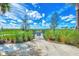 Entrance to a well-maintained dog park with lush landscaping and a secure fence for a safe play environment at 9487 Tequila Sunrise Dr, Sarasota, FL 34241