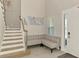 Inviting foyer featuring a staircase, stylish seating, and a bright, welcoming ambiance at 9487 Tequila Sunrise Dr, Sarasota, FL 34241