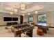 Bright and spacious game room featuring a foosball table, pool table, and multiple televisions for entertainment at 9487 Tequila Sunrise Dr, Sarasota, FL 34241