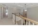Upstairs hallway with contemporary railings and eye-catching pendant lighting, freshly painted in neutral colors at 9487 Tequila Sunrise Dr, Sarasota, FL 34241