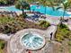 Inviting bubbling hot tub surrounded by lush landscaping and lounge seating near the main pool at 9487 Tequila Sunrise Dr, Sarasota, FL 34241