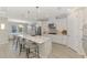 Bright kitchen boasts an island with seating, modern stainless appliances, and light, neutral tones at 9487 Tequila Sunrise Dr, Sarasota, FL 34241