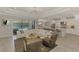 Open-concept living room with modern decor and large sliding doors to the pool at 9487 Tequila Sunrise Dr, Sarasota, FL 34241