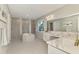 This luxurious bathroom boasts double vanities, a large tub, and a tiled shower with modern fixtures at 9487 Tequila Sunrise Dr, Sarasota, FL 34241