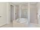 Bright bathroom features a tub and tiled walk-in shower that enhances the spa-like feel at 9487 Tequila Sunrise Dr, Sarasota, FL 34241