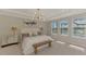 Spacious main bedroom features a modern light fixture, ensuite bath, and large windows at 9487 Tequila Sunrise Dr, Sarasota, FL 34241