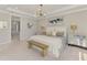 This expansive main bedroom features a bench, stylish decor, and neutral tones for a relaxing retreat at 9487 Tequila Sunrise Dr, Sarasota, FL 34241