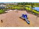 Enjoy the community playground with playset, swings, and views of the lake at 9487 Tequila Sunrise Dr, Sarasota, FL 34241
