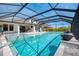 Beautiful screened-in pool and patio with hot tub, fire pit, and outdoor seating area at 9487 Tequila Sunrise Dr, Sarasota, FL 34241