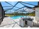 Screened-in pool and patio area with a dining table and chairs and views of the outdoor space at 9487 Tequila Sunrise Dr, Sarasota, FL 34241