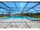 Stunning screened pool and spa with brick pavers overlooking a lush backyard at 9487 Tequila Sunrise Dr, Sarasota, FL 34241